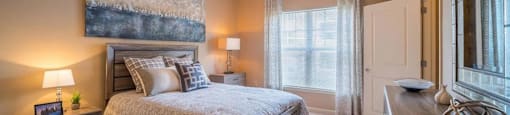 a bedroom with a bed and a ceiling fan