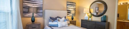 a bedroom with a large bed and a ceiling fan