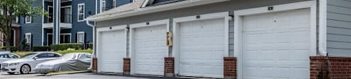 A row of garage doors in front of a building.