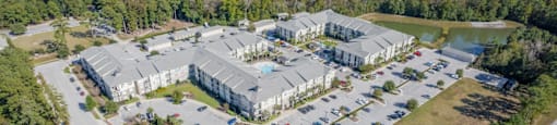 an aerial view of the apartments and parking lot