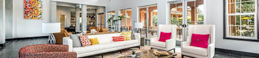 a living room with couches and chairs and a table