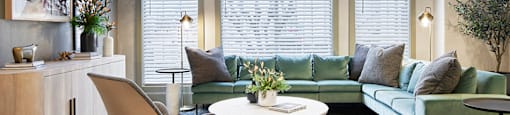 a living room with a green couch and a table