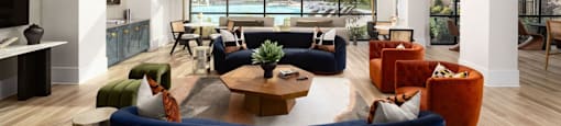 A living room with a blue couch and a coffee table at Liam at Hays Farm in Huntsville, Alabama
