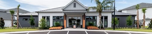 A building with a parking lot in front of it.