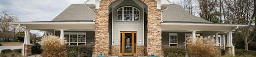 the front of a house with a walkway and a front door