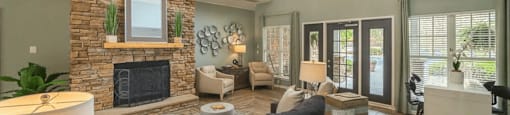 a living room with a stone fireplace and a couch