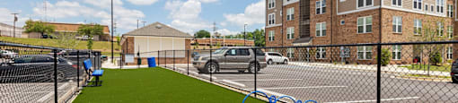a fence with olympic rings in front of a building