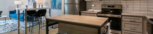 a kitchen with stainless steel appliances and a wooden island