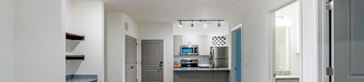 a renovated living room and kitchen with a hard wood floor