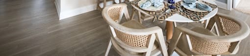 A kitchen with a dining table set for two.