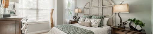a bedroom with a bed and a dresser and a window
