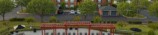 an aerial view of a swimming pool with a hotel in the background