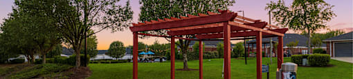 a park with a pavilion and a trash can