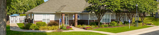 a home in a neighborhood with trees and a sidewalk