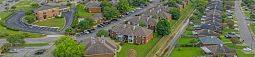 an aerial view of a neighborhood with houses and cars