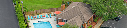a house with a swimming pool and a parking lot