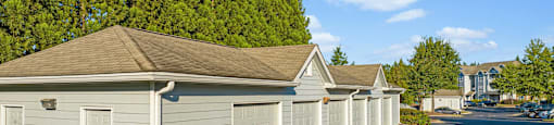 a row of white garages in a parking lot