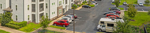 an aerial view of an apartment complex with a parking lot
