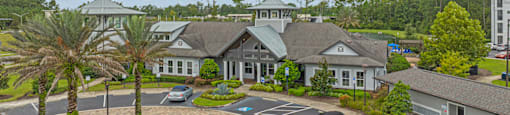 an aerial view of a large building with cars parked in front of it