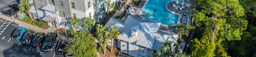an aerial view of a hotel and resort with a swimming pool
