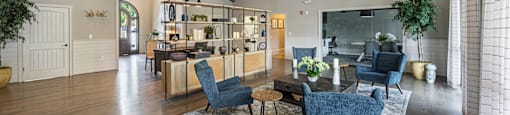 a living room with a dining room table and chairs