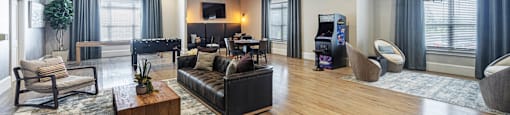 a living room with couches and chairs and a tv