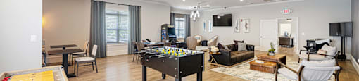 a living room with a pool table and a ceiling fan