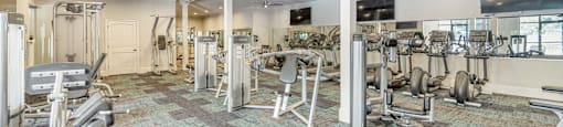a gym with weights and cardio equipment in a room with glass doors