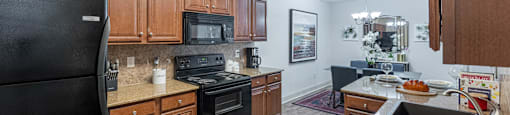 a kitchen with black appliances and wooden cabinets