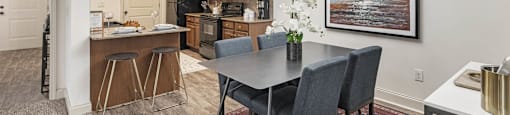 a kitchen and dining room with a table and chairs
