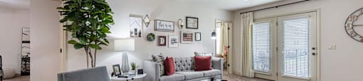 a living room with furniture and a ceiling fan