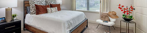 a bedroom with a bed and a ceiling fan