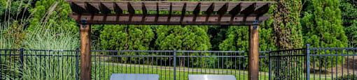 a brick patio with two stainless steel barbecue grills