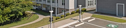 an empty parking lot in front of an apartment building