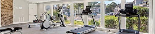modern fitness center with free weights and treadmills