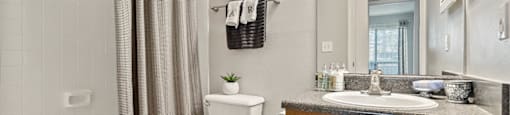 spacious bathroom with tub and shower, toilet, and sink