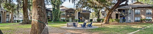 firepit and lounge area with hammocks under beautiful south carolina trees