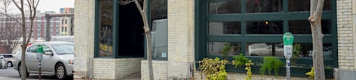 A white building with a green door and a sign that says "Royal Oak".