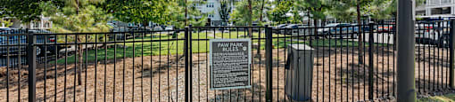 A sign in front of a fence reads "PAWELS PARK".