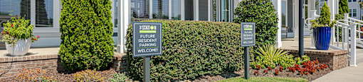 the front of a building with signs on the sidewalk