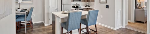 a kitchen and dining room with a table and chairs