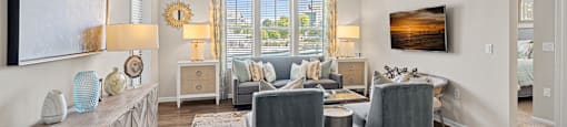 a living room with furniture and a ceiling fan