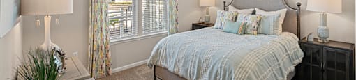 a bedroom with a large bed and a window