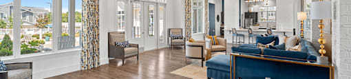 a living room with a blue couch and a large window