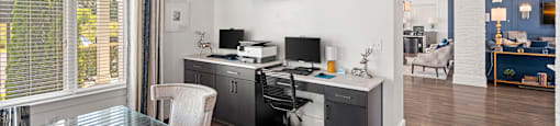 a kitchen and dining room with a desk and a tv