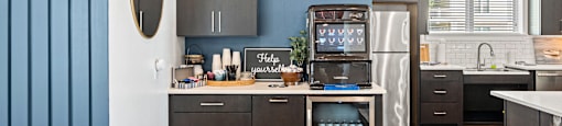 a kitchen with blue walls and a stainless steel refrigerator