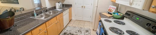 a kitchen with cabinets and a stove and a sink