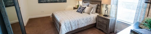 a bedroom with a bed and a ceiling fan