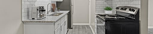 a kitchen with white cabinetry and black appliances