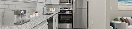 a kitchen with white cabinets and stainless steel appliances